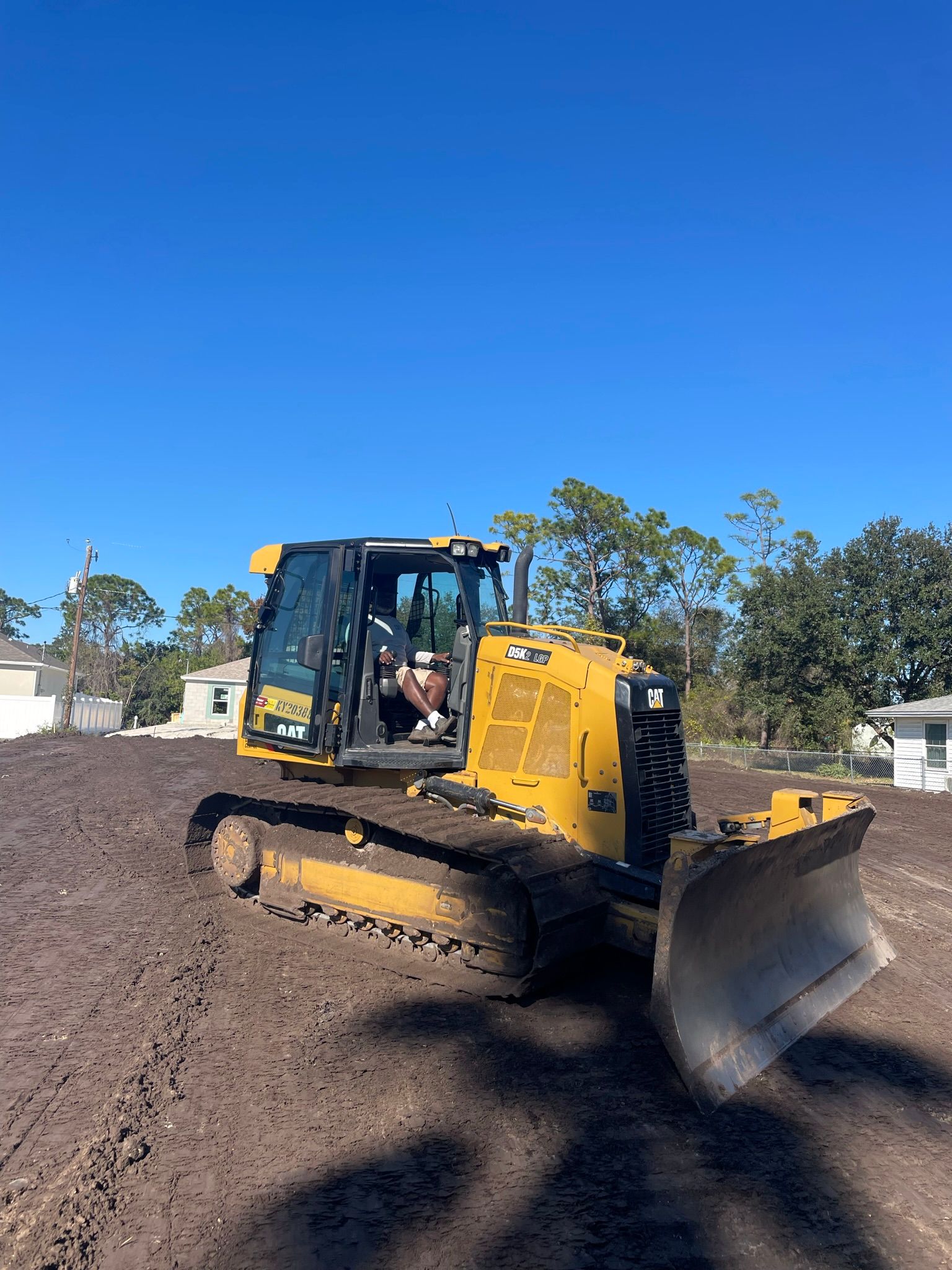 Dozer on a graded building pad in a neighborhood